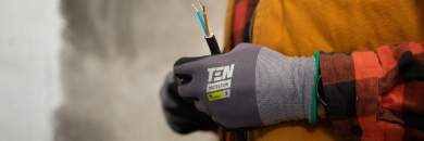 A technician holding a thick power cable.